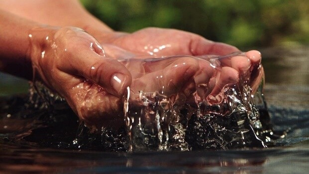 hands collecting clean water